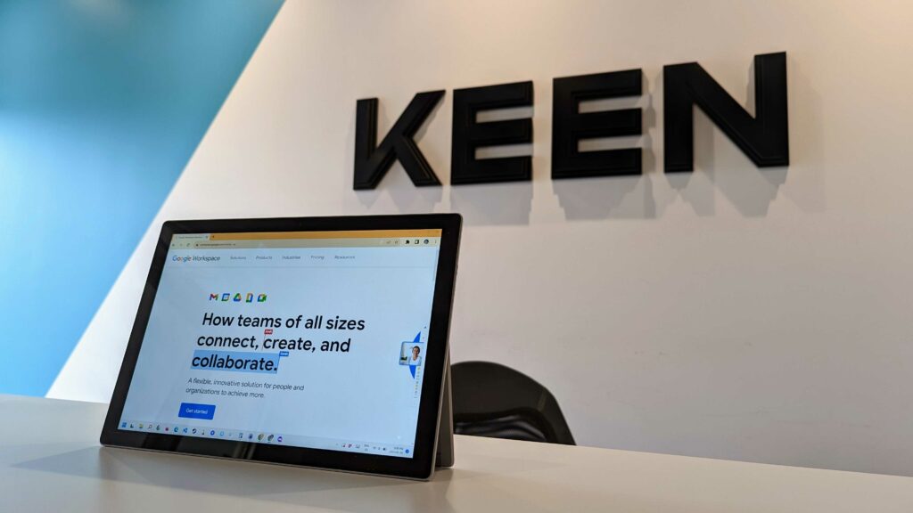 An image of a Tablet showing Google Workspace on its screen in front of Keens Logo.